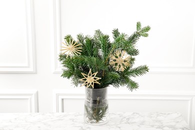 Photo of Beautiful decorated fir tree branches on white table. Christmas season