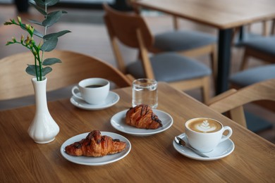 Photo of Delicious breakfast served on wooden table in cafe