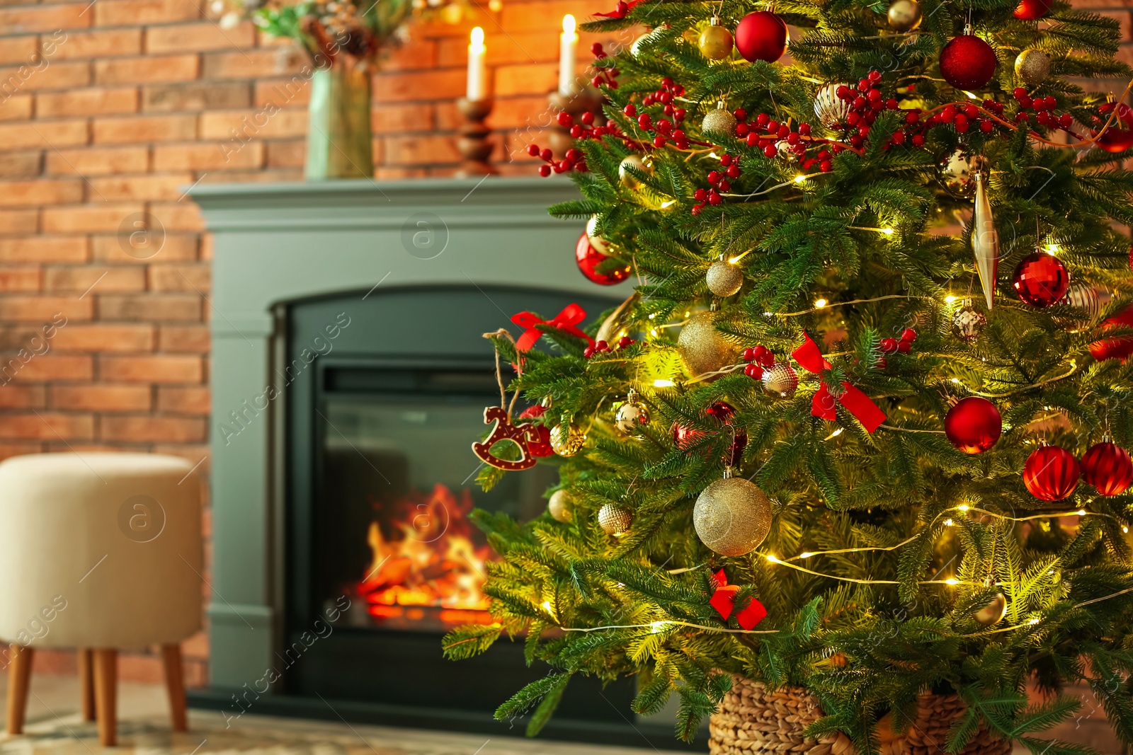 Photo of Beautiful decorated Christmas tree near fireplace at home, closeup. Space for text