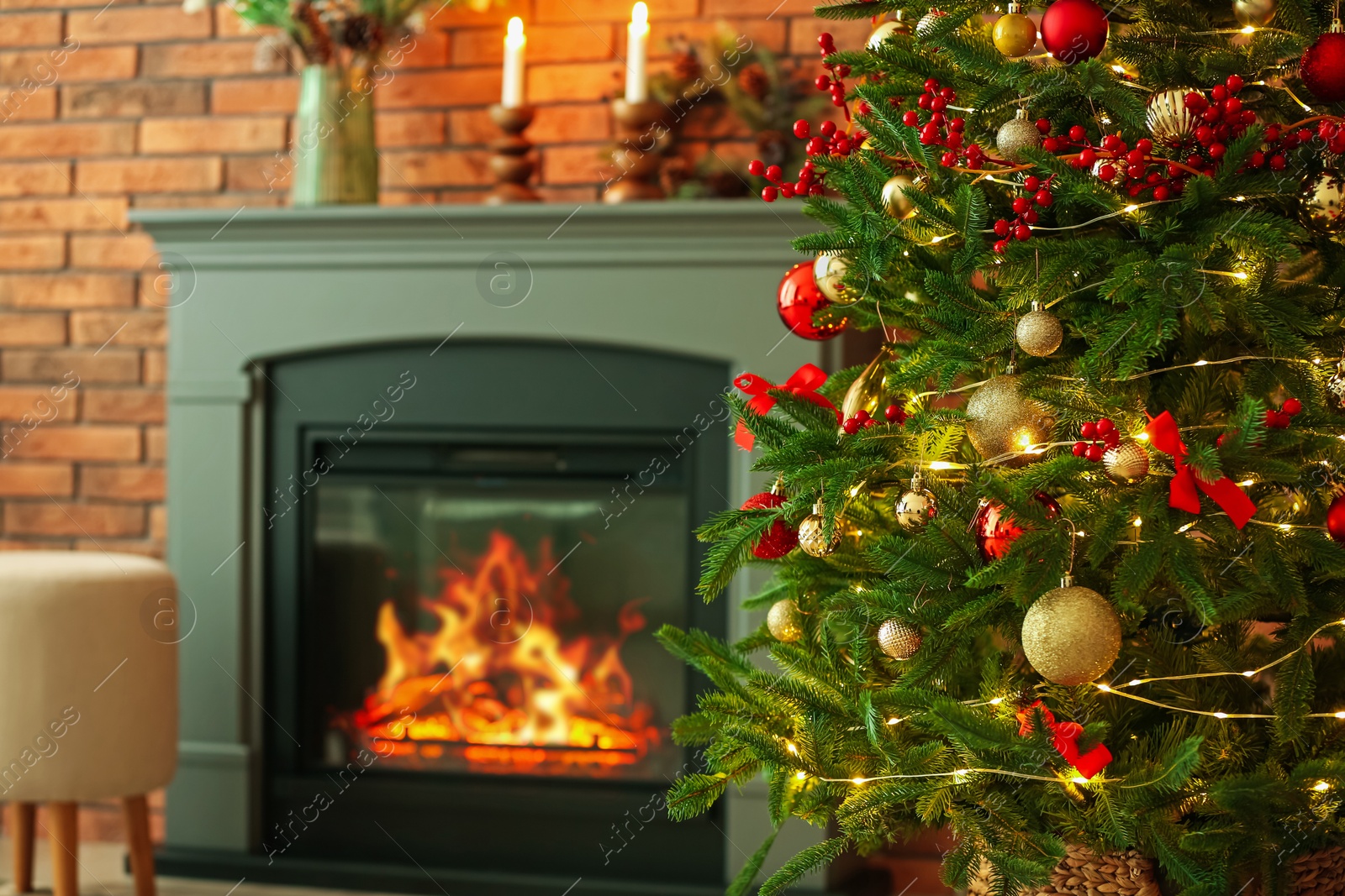 Photo of Beautiful decorated Christmas tree near fireplace at home, closeup. Space for text