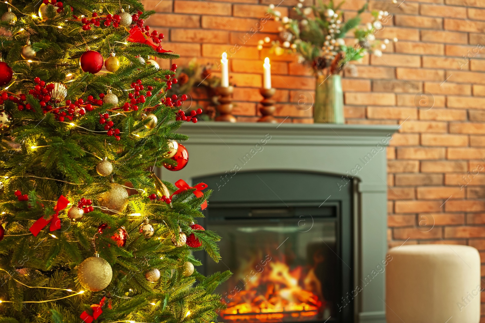 Photo of Beautiful decorated Christmas tree near fireplace at home, closeup. Space for text