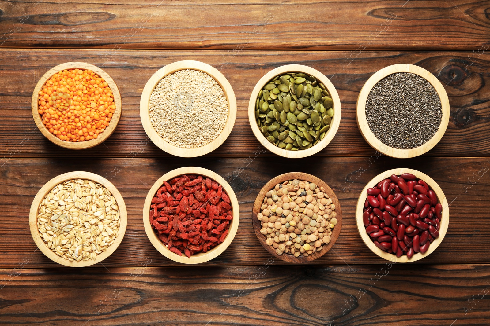 Photo of Different superfood products on wooden table, flat lay