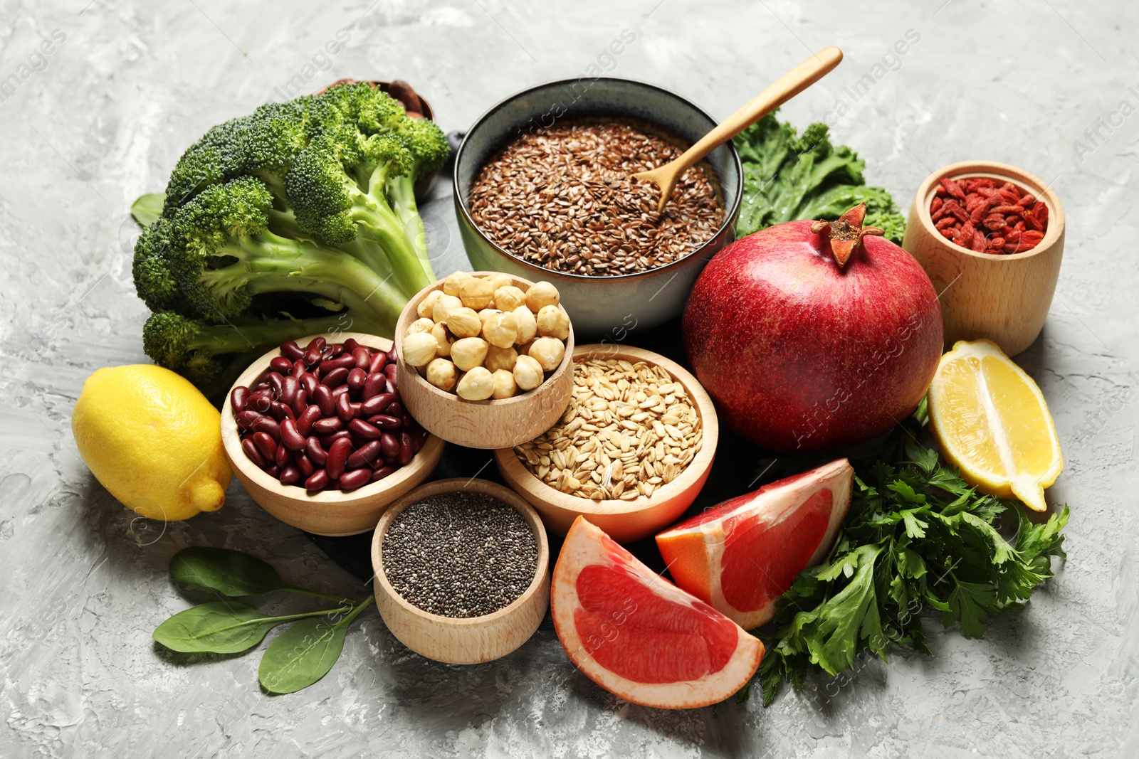 Photo of Different superfood products on grey textured table