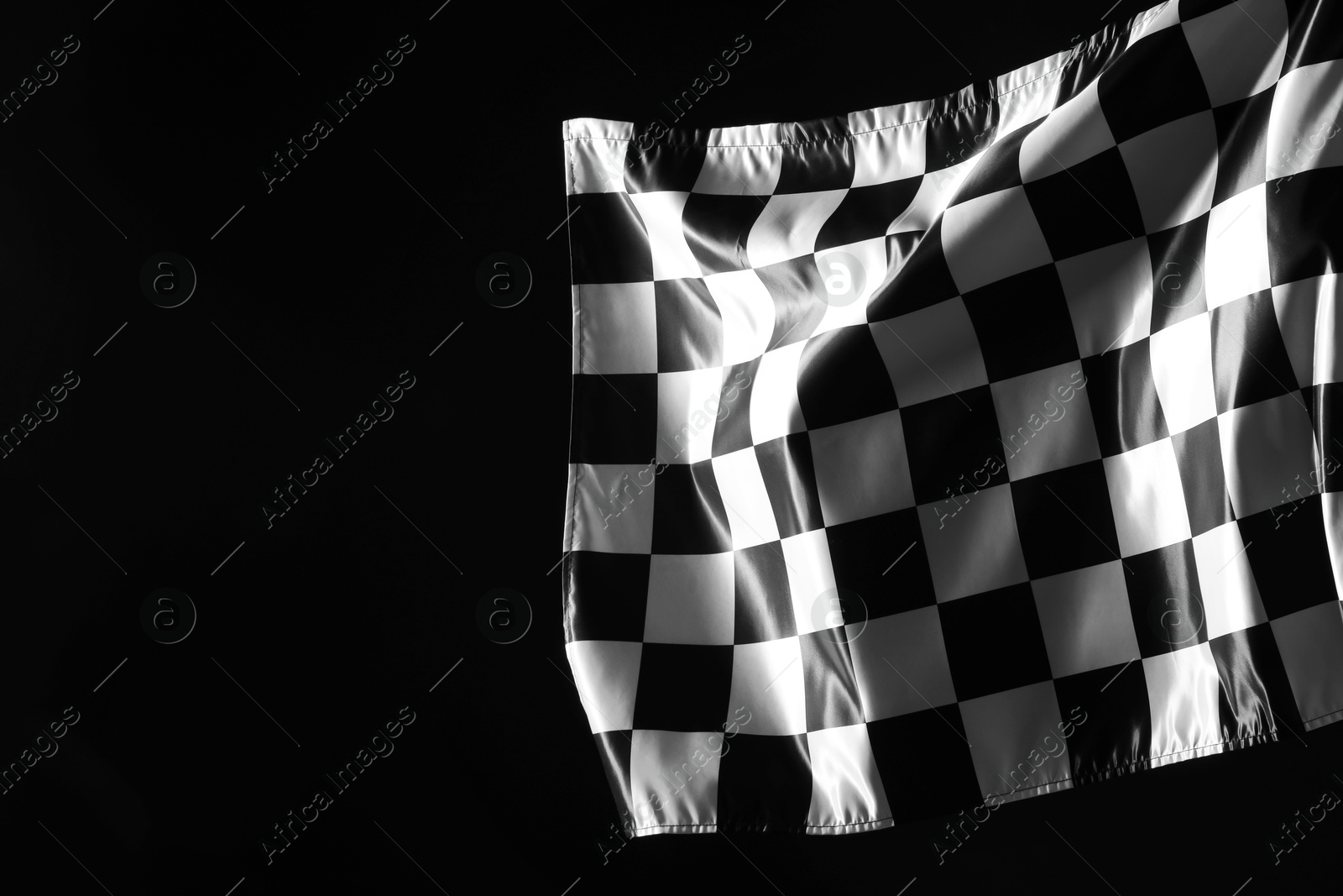 Photo of One racing checkered flag on black background, space for text