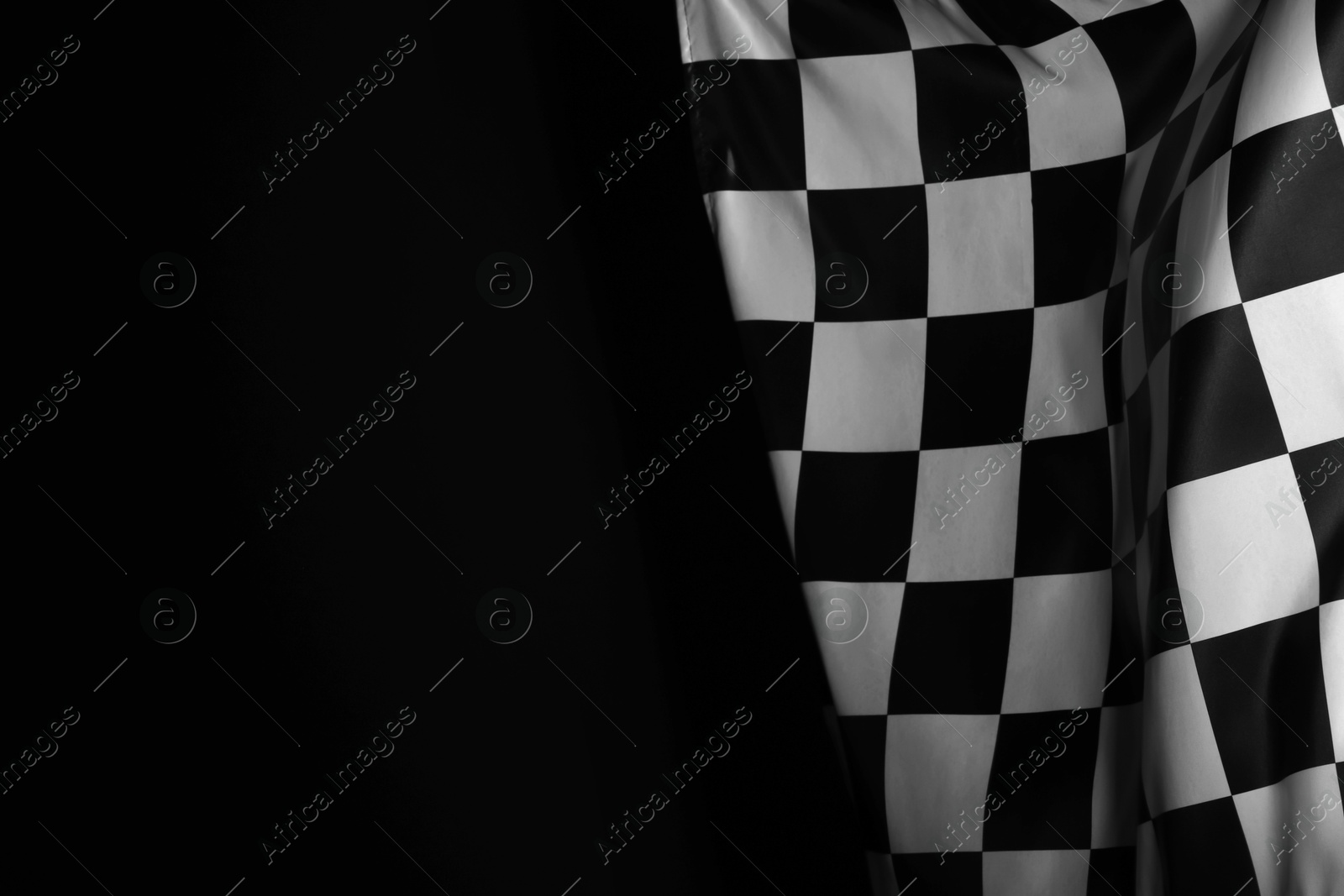 Photo of One racing checkered flag on black background, space for text