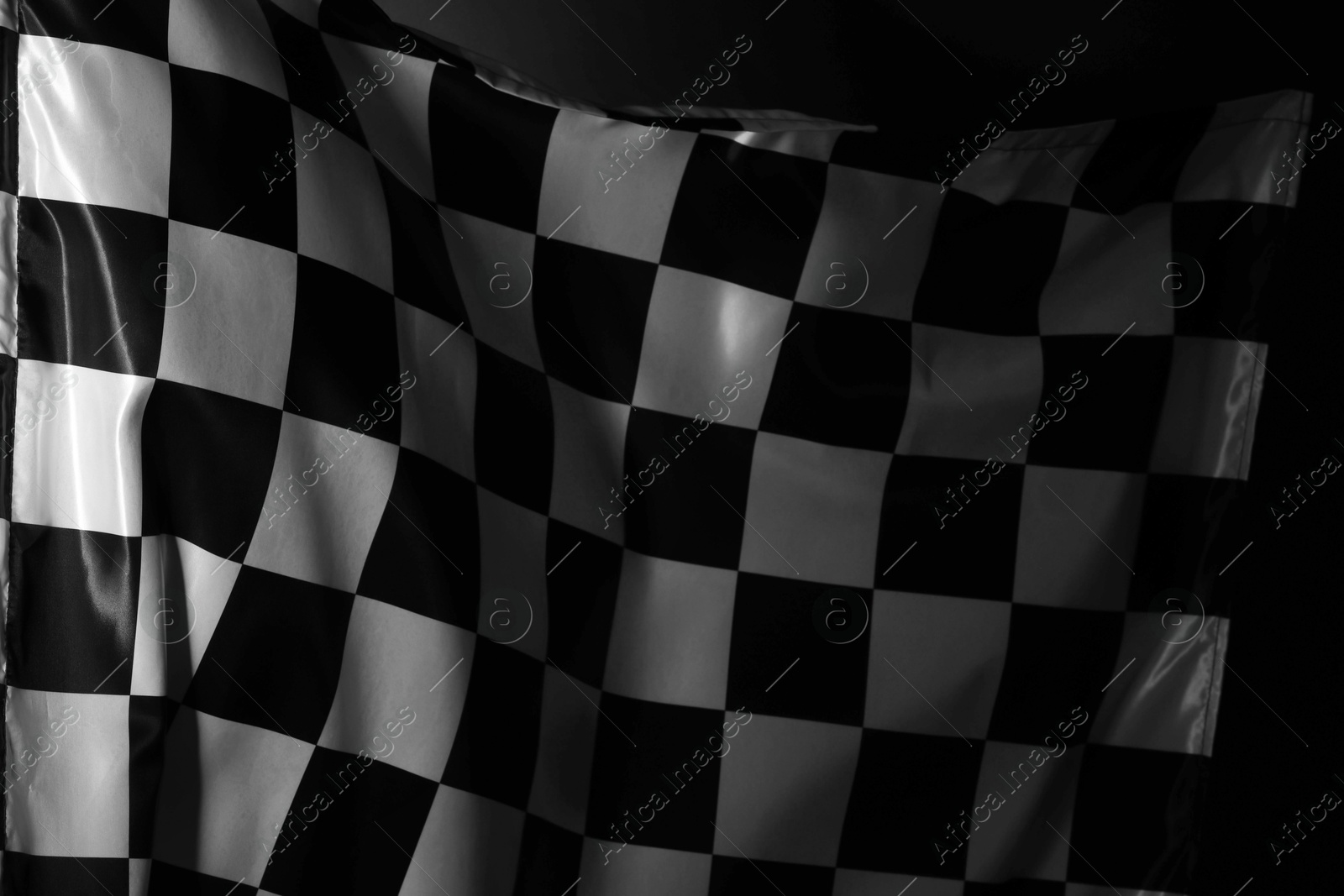 Photo of Racing checkered flag as background, closeup view