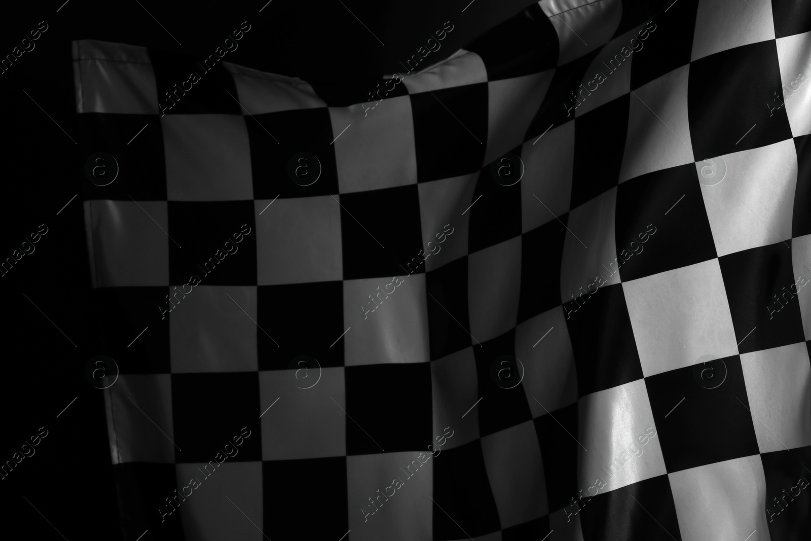 Photo of Racing checkered flag as background, closeup view