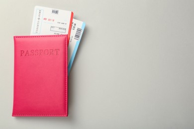 Photo of Passport with tickets on light background, top view. Space for text