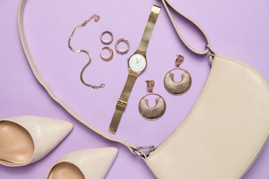 Photo of Flat lay composition with golden jewelry and accessories on violet background