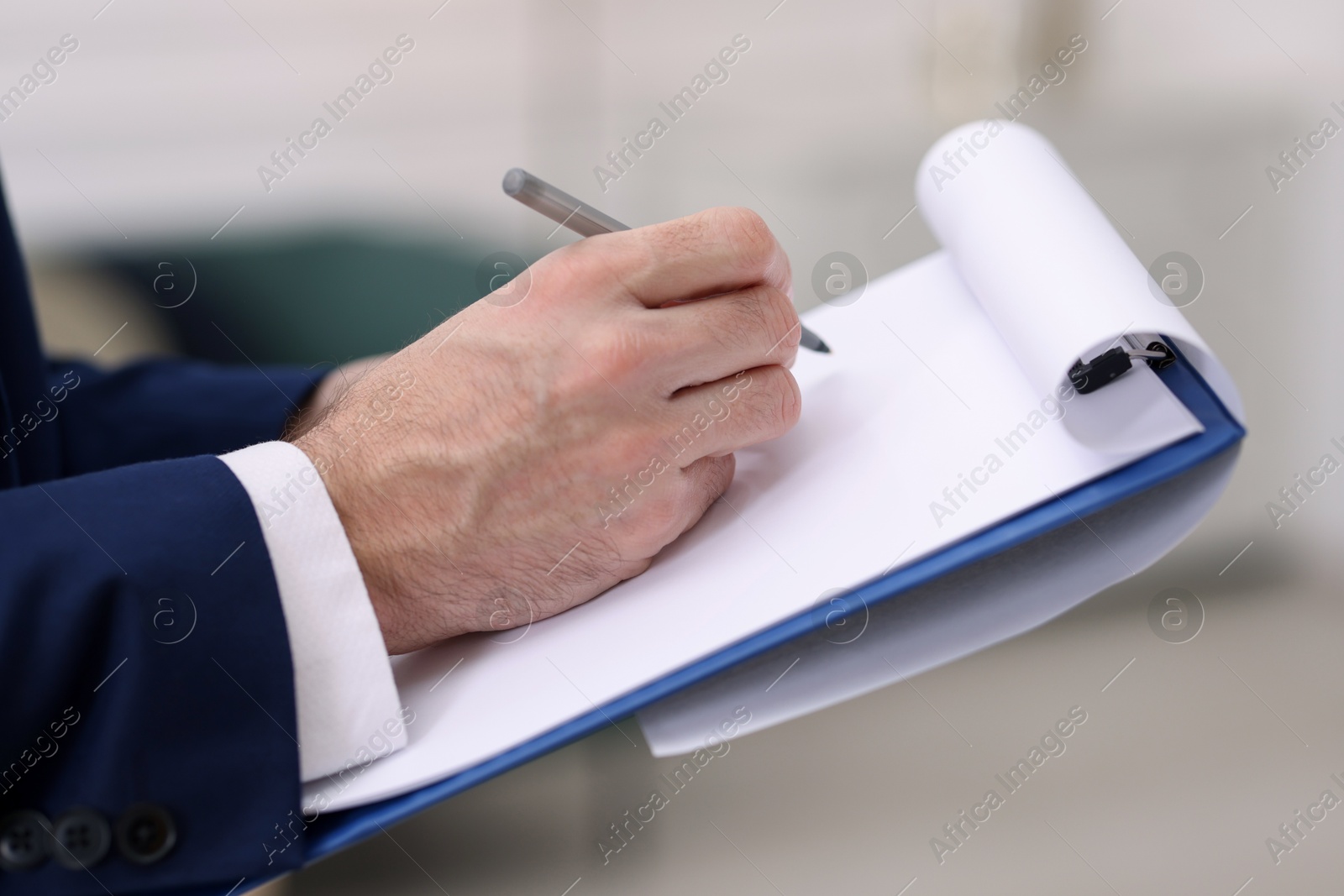 Photo of Real estate appraisal. Inspector with clipboard conducting property valuation indoors, closeup