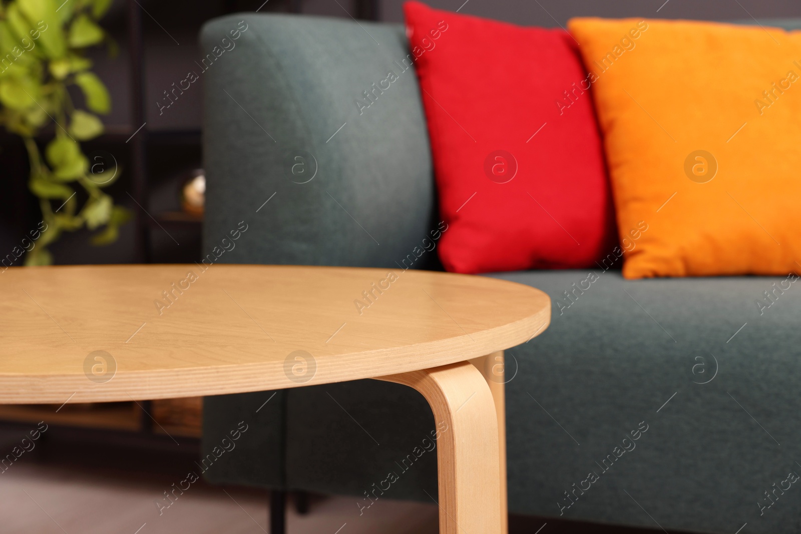 Photo of Stylish coffee table near sofa at home, closeup