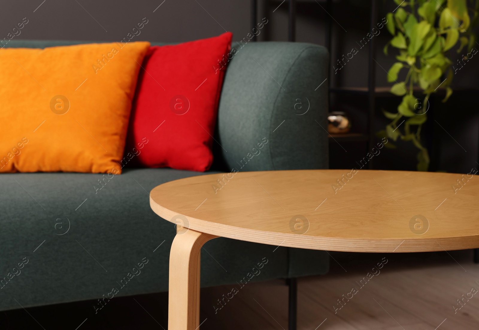 Photo of Stylish coffee table near sofa at home, closeup