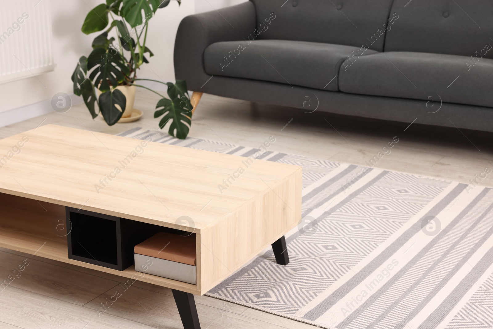 Photo of Stylish wooden coffee table in living room