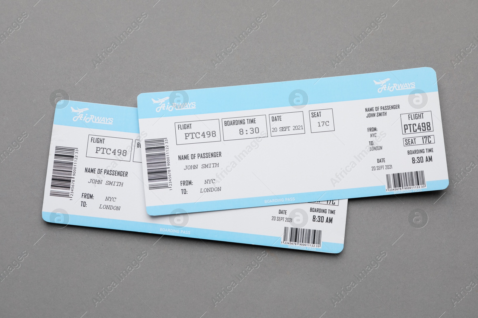 Photo of Travel agency. Flight tickets on grey background, top view