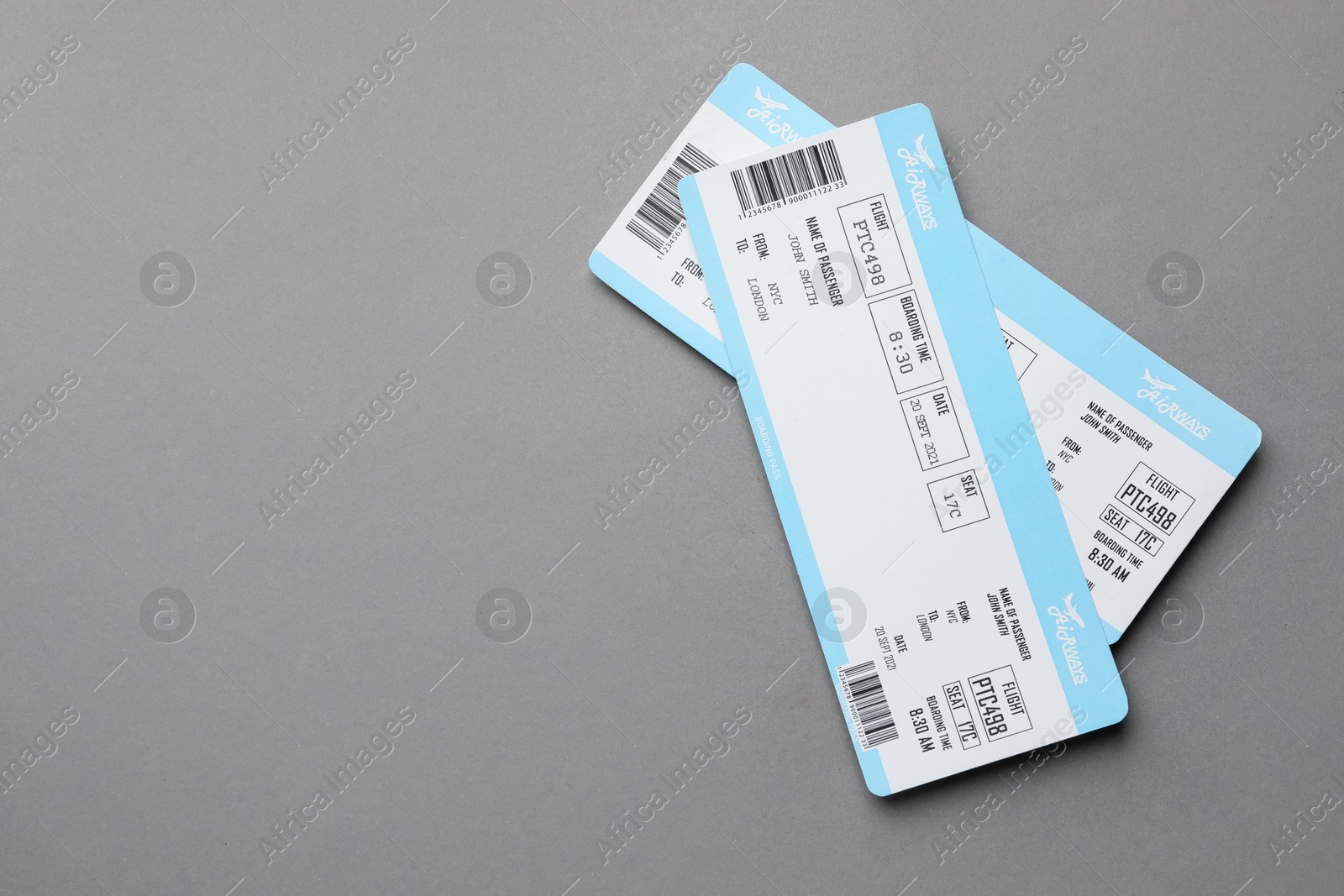 Photo of Travel agency. Flight tickets on grey background, top view. Space for text