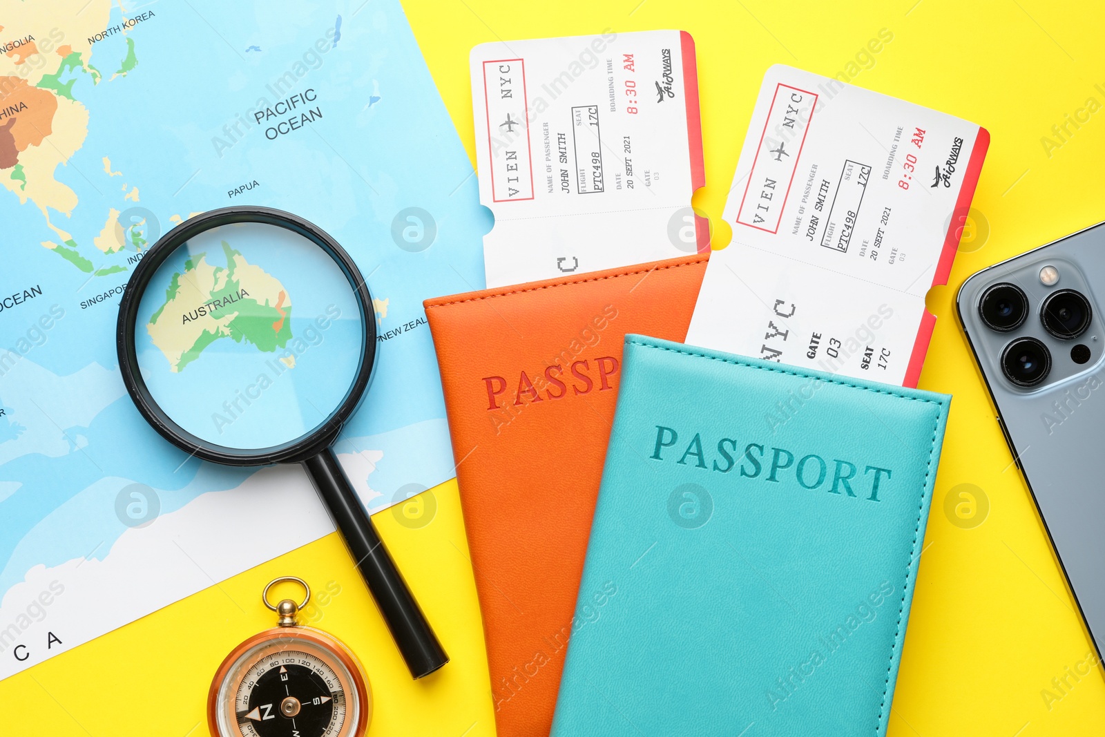 Photo of Travel agency. Flat lay composition with flight tickets on yellow background