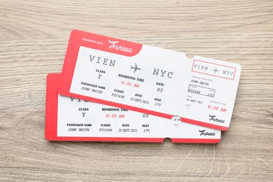 Photo of Travel agency. Flight tickets on wooden table, top view