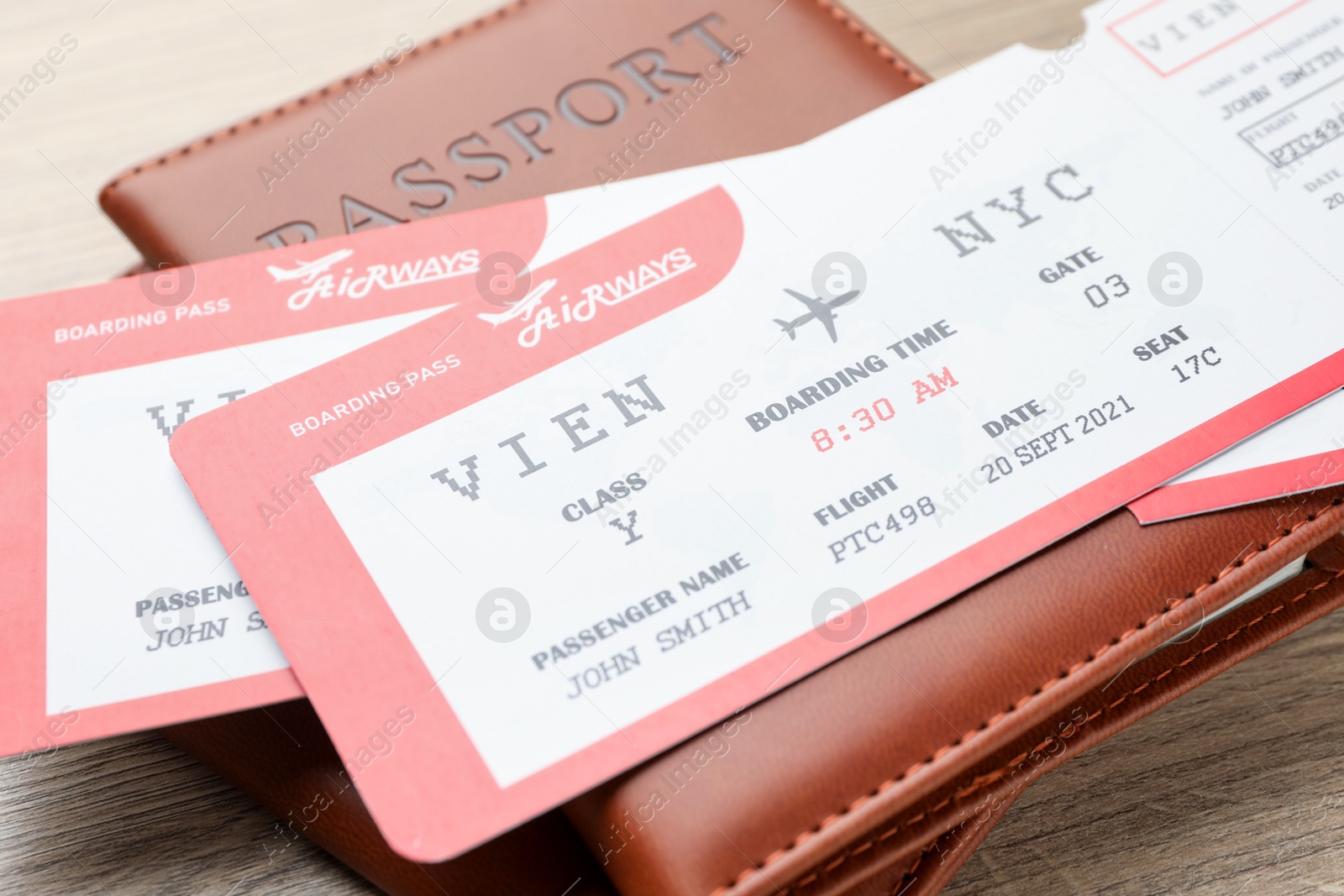 Photo of Travel agency. Flight tickets and passports on wooden table, closeup