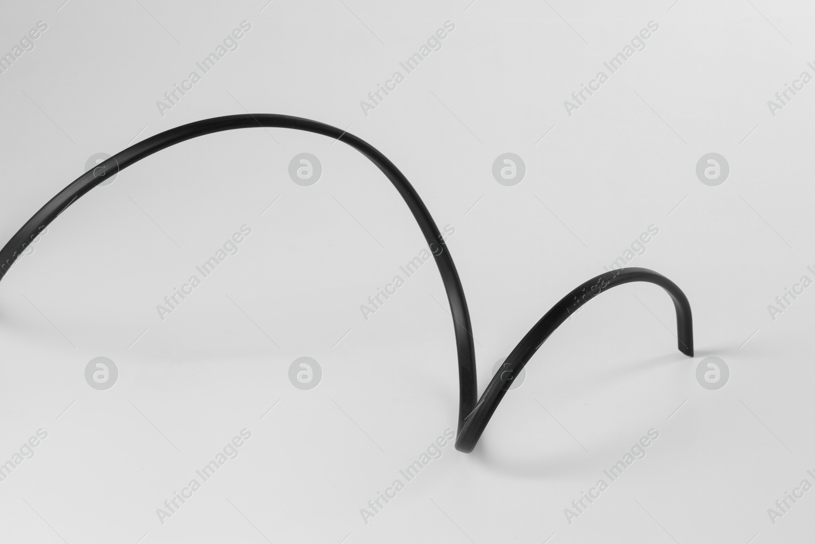 Photo of One black electrical wire isolated on white