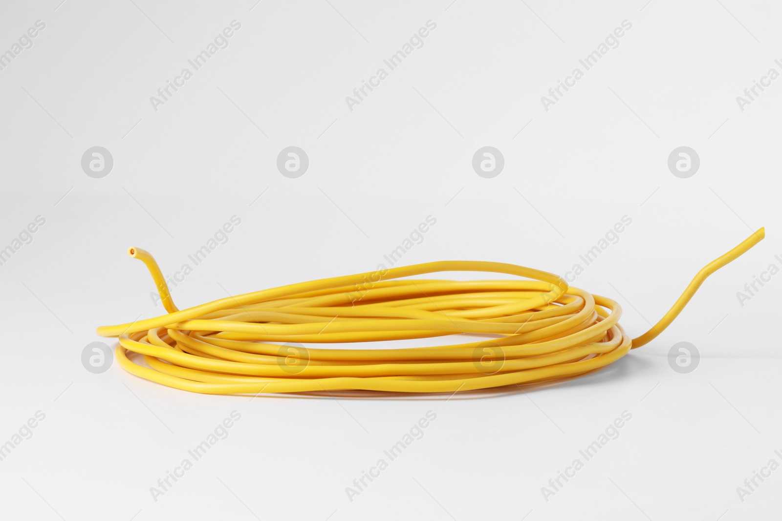 Photo of Insulated yellow electrical wire isolated on white