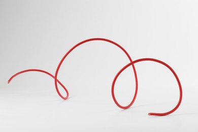 Photo of One red electrical wire isolated on white