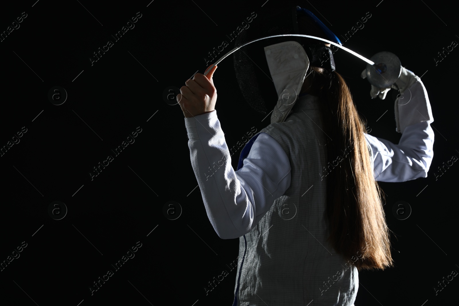 Photo of Fencer with epee on black background, space for text