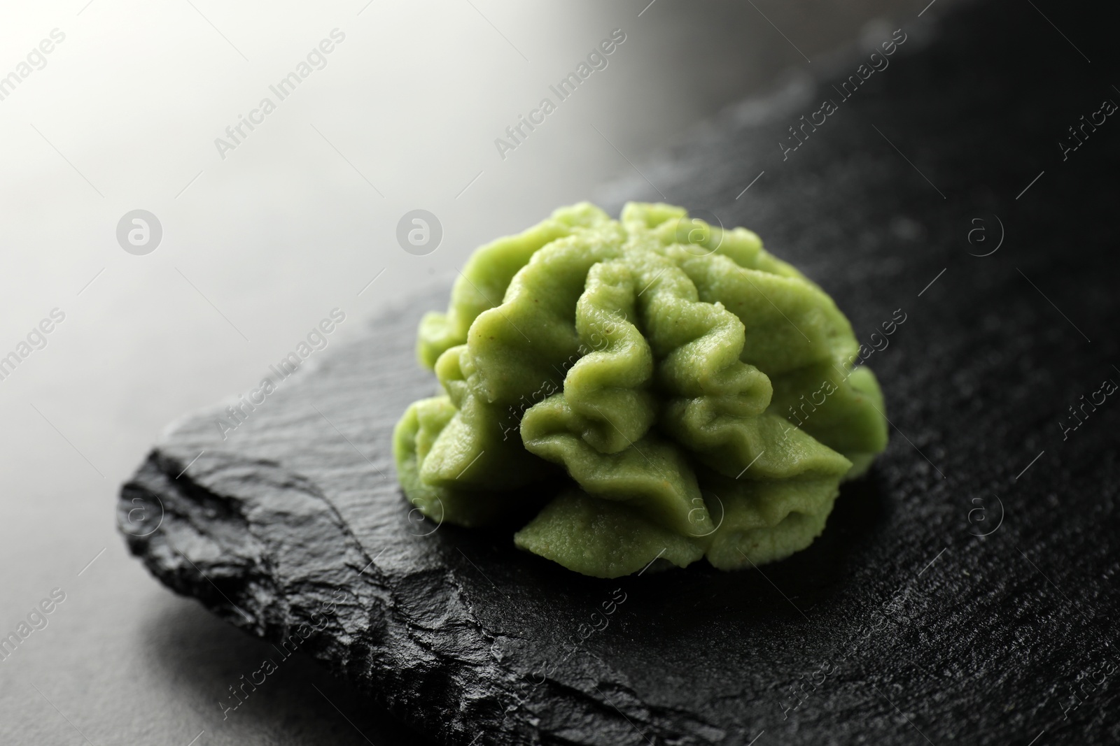 Photo of Hot wasabi paste on grey table, closeup