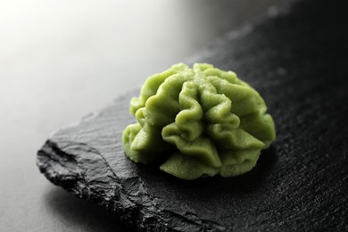 Photo of Hot wasabi paste on grey table, closeup