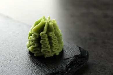 Photo of Hot wasabi paste on grey table, closeup. Space for text