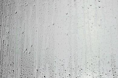 Water drops on grey glass surface, top view