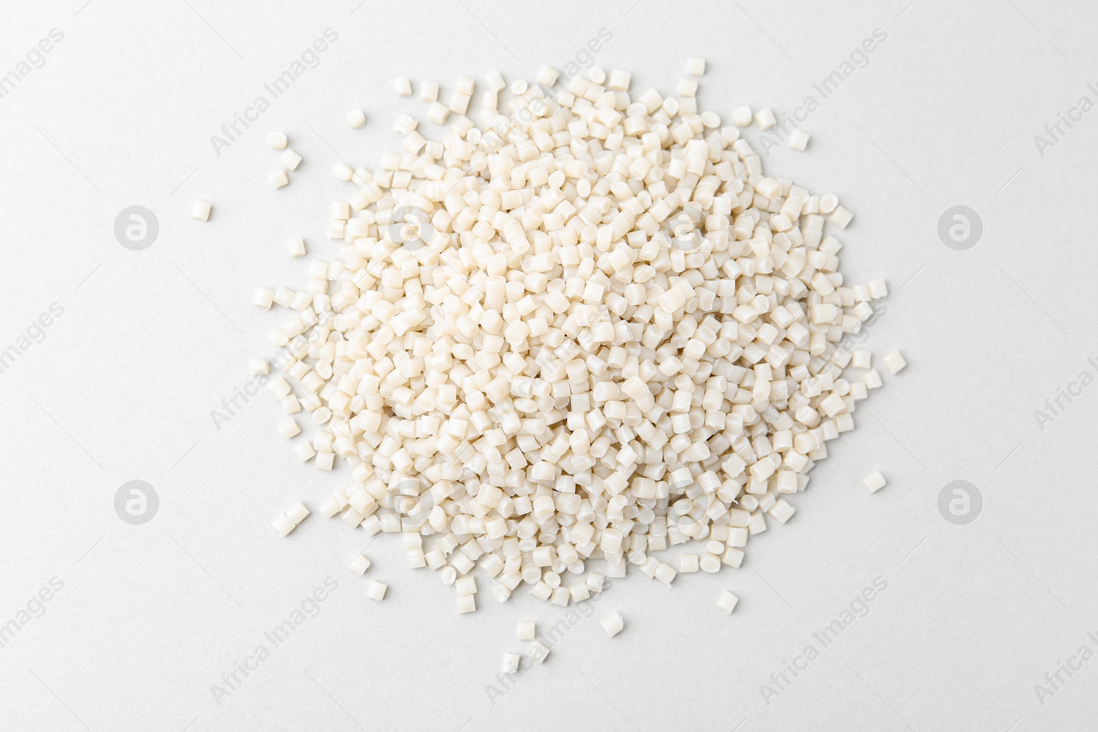 Photo of Pile of plastic granules on white background, top view