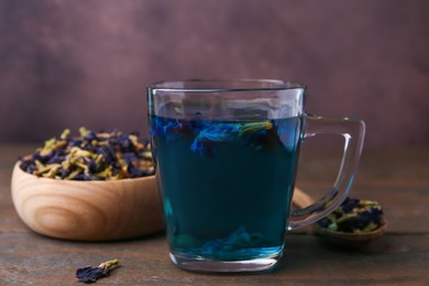 Delicious butterfly pea flower tea on wooden table