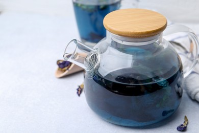 Delicious butterfly pea flower tea on white table, closeup