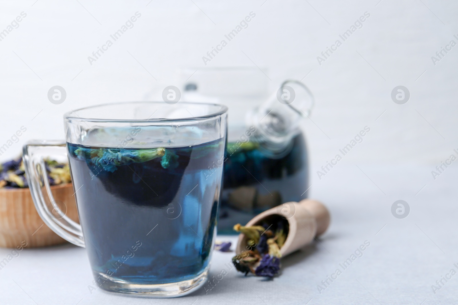 Delicious butterfly pea flower tea on white table Photo of Delicious butterfly pea flower tea on white table