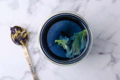 Delicious butterfly pea flower tea on white marble table, top view