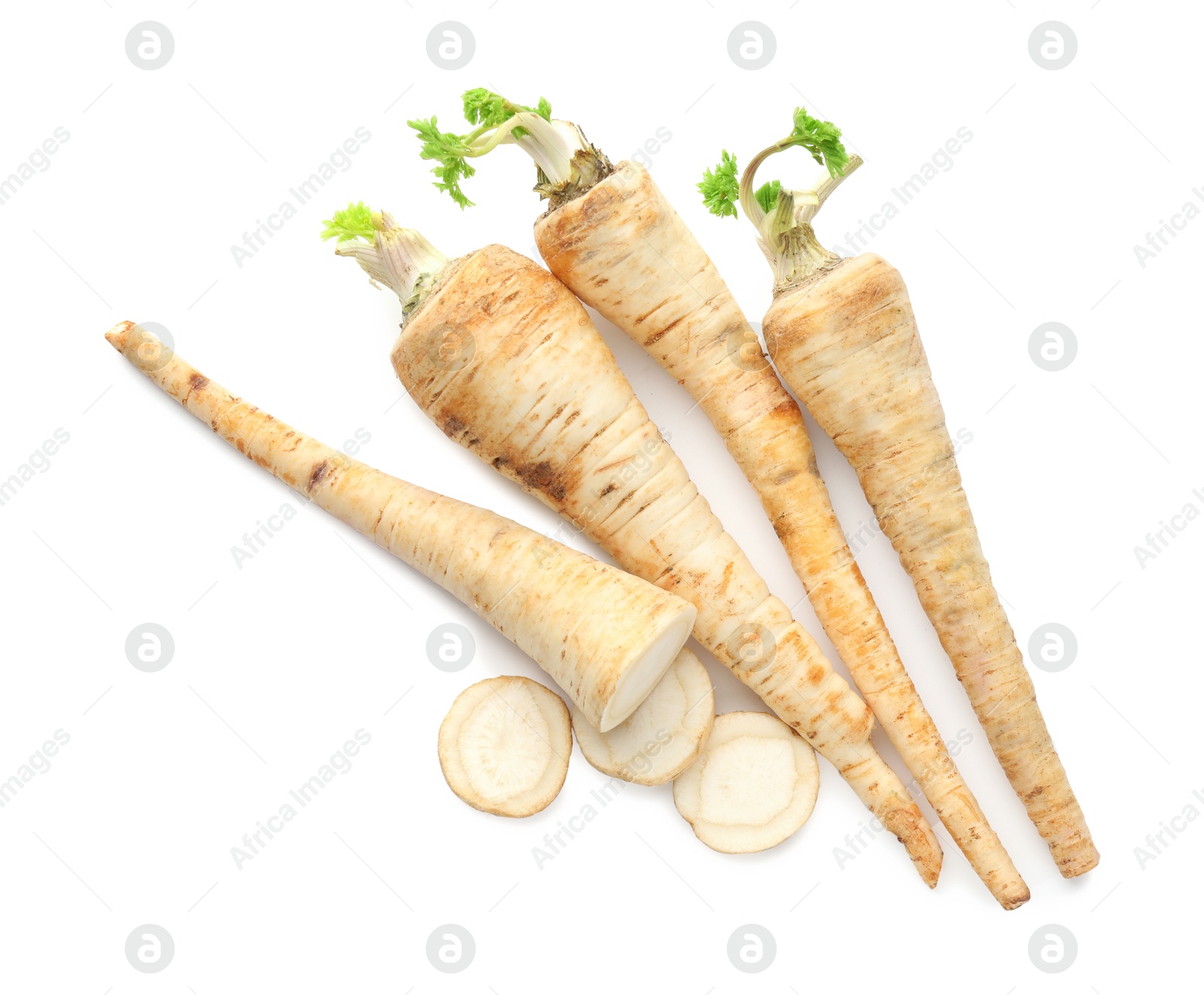 Photo of Whole and cut fresh parsley roots isolated on white, top view