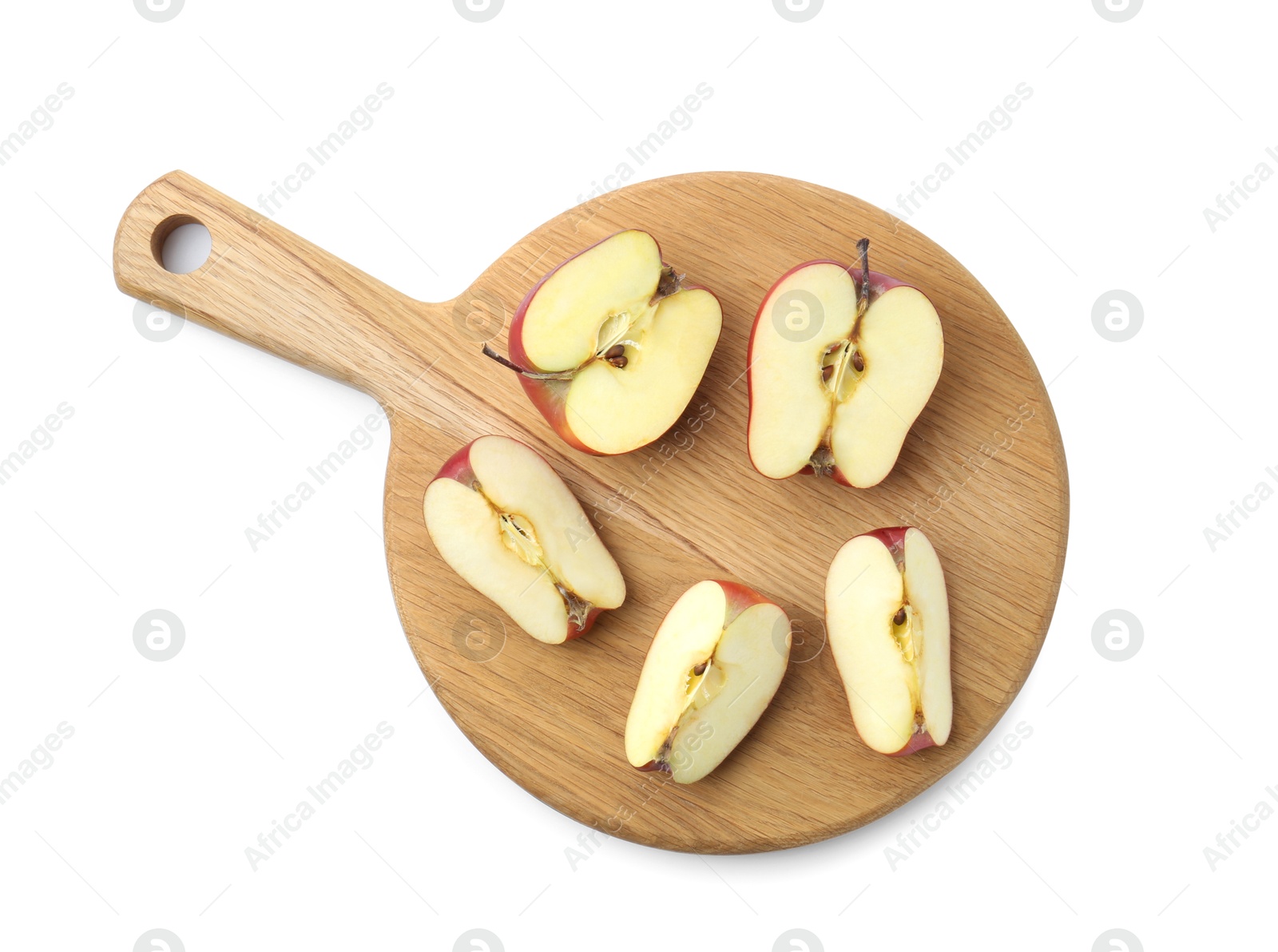 Photo of Wooden cutting board with cut apples isolated on white, top view