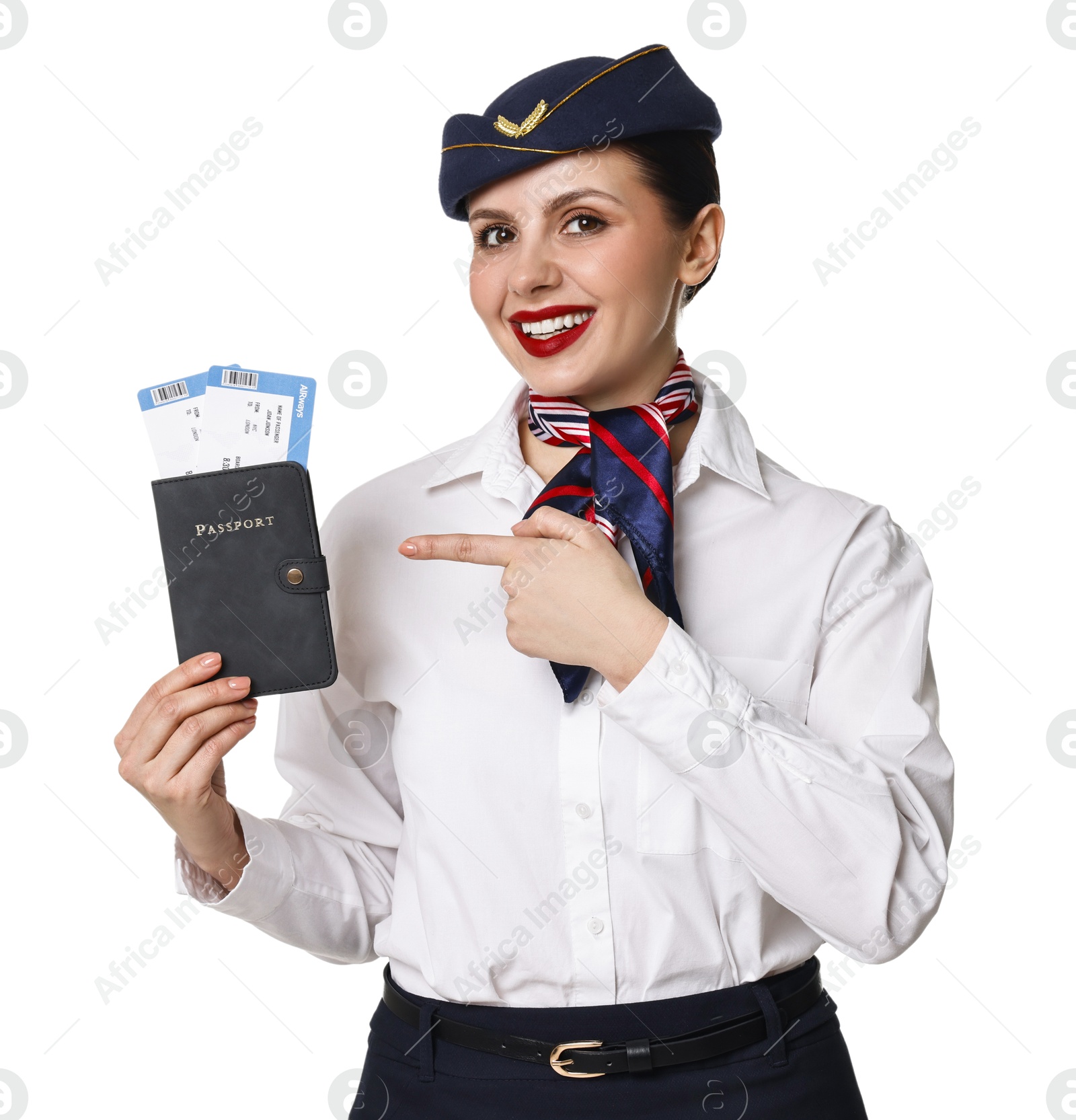 Photo of Happy stewardess pointing at passport with flight tickets on white background