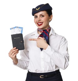 Photo of Happy stewardess pointing at passport with flight tickets on white background