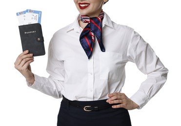 Happy stewardess holding passport with flight tickets on white background, closeup