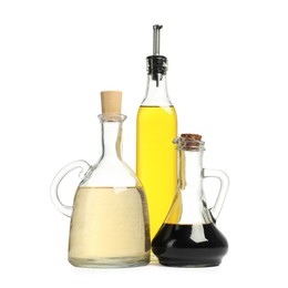 Photo of Oil and vinegar in bottles isolated on white