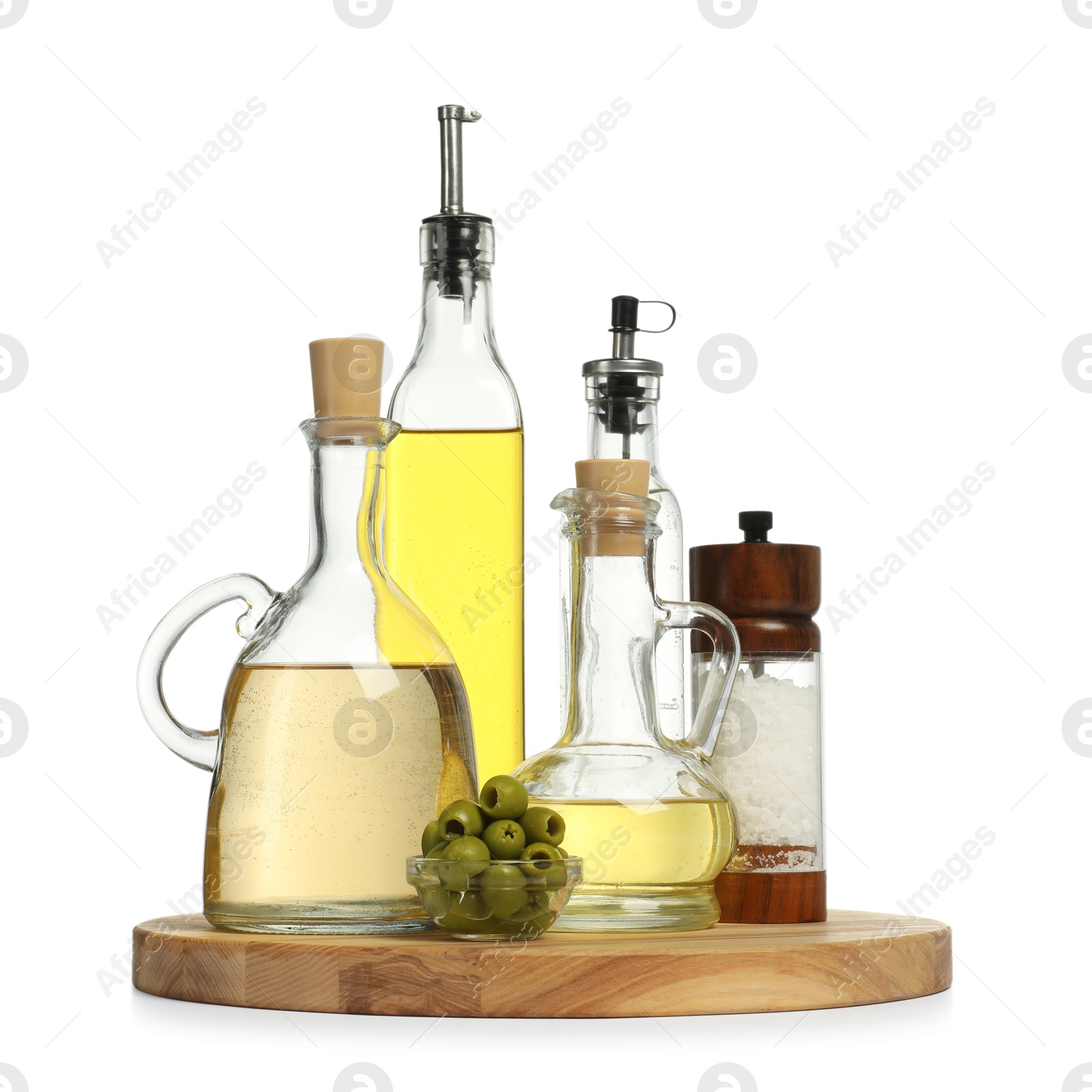 Photo of Salad dressings, salt and olives isolated on white