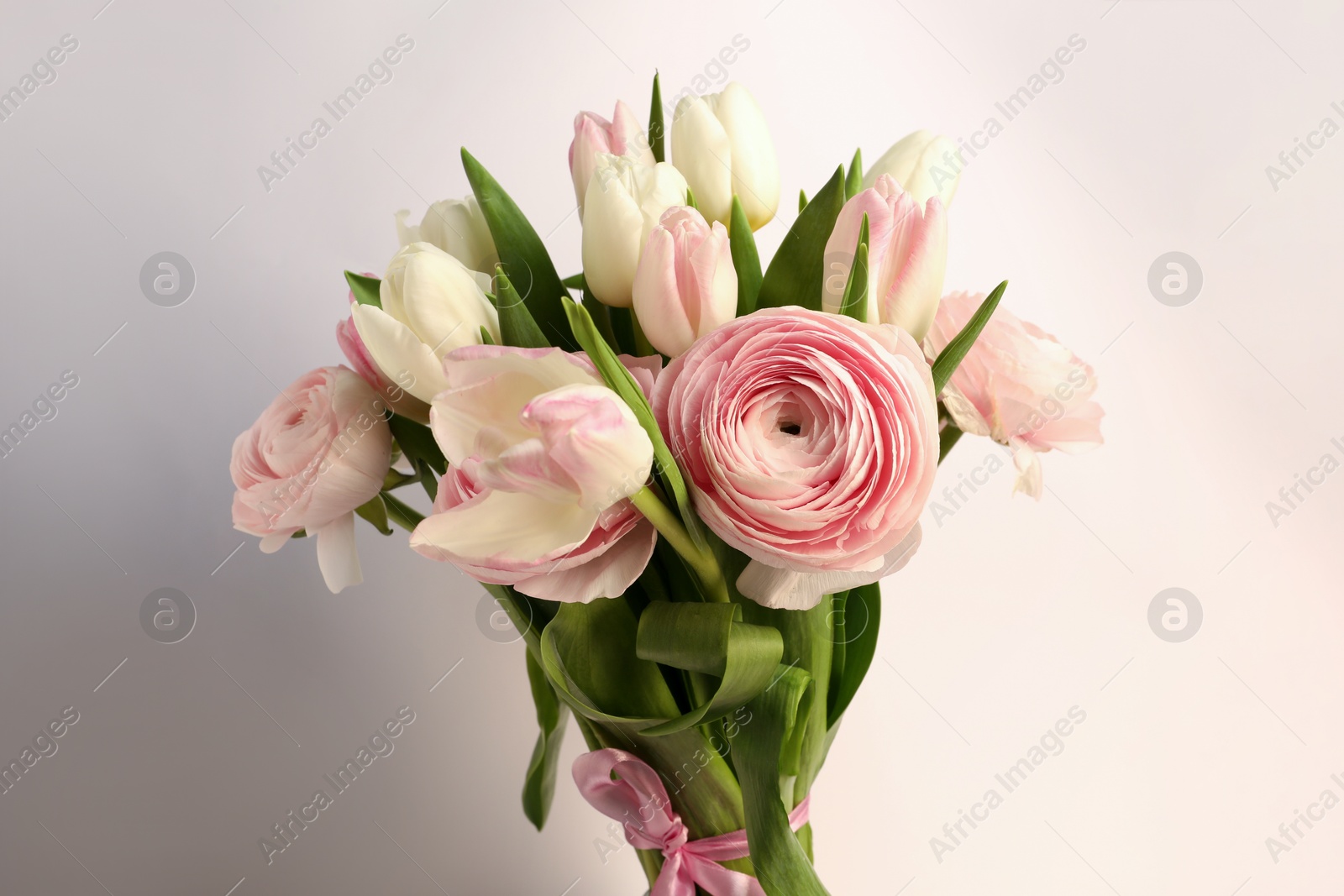 Photo of Bouquet of beautiful ranunculus and tulip flowers on white background, closeup