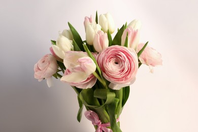 Photo of Bouquet of beautiful ranunculus and tulip flowers on white background, closeup