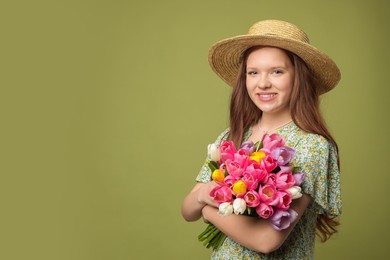 Photo of Beautiful teenage girl with bouquet of tulips on olive background, space for text