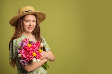 Photo of Beautiful teenage girl with bouquet of tulips on olive background, space for text