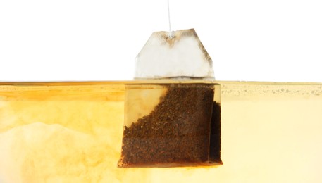 Photo of Putting tea bag into glass cup on white background, closeup