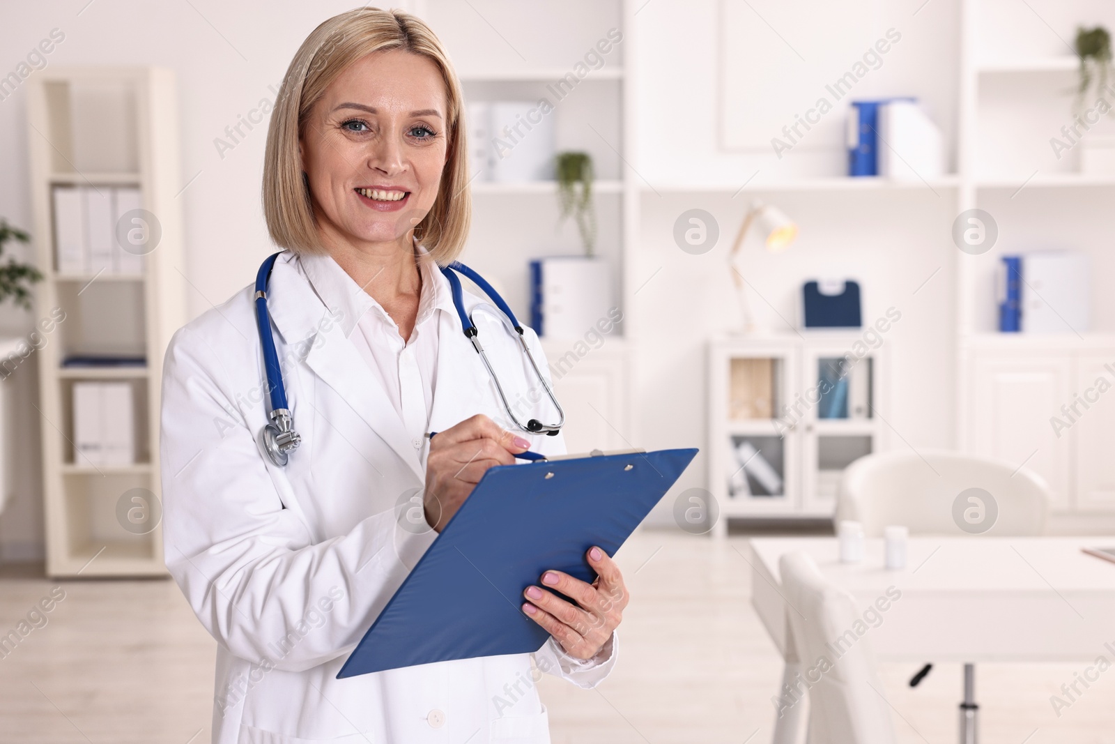 Photo of Weight loss. Smiling nutritionist with clipboard in clinic, space for text