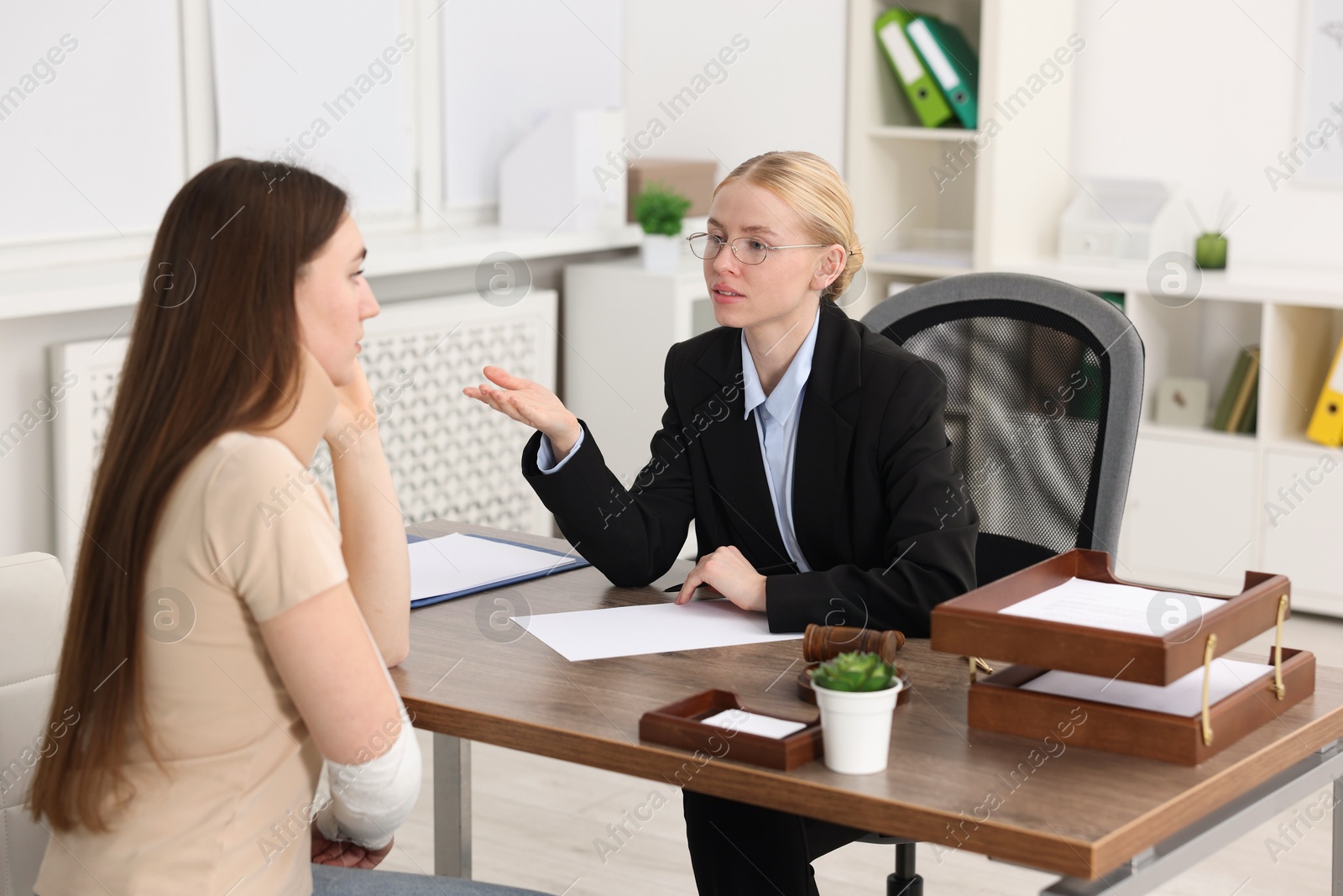 Photo of Injured woman having meeting with lawyer in office