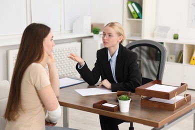 Photo of Injured woman having meeting with lawyer in office